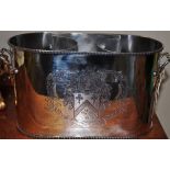 A silver plated two handled two bottle wine cooler with engraved armorial