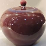 A Chinese lidded ginger jar in Sang de boeuf glaze, H20.