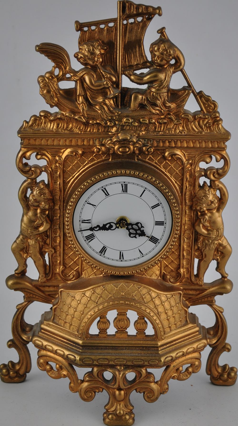 Baroque-style gilt metal clock with battery-powered quartz movement. H.