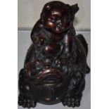 A Chinese bronze luck frog carrying a child on its back, bears four character mark to the base,