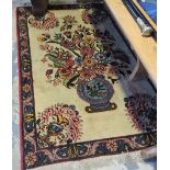 A Persian Sarogh hand-made wool rug with central floral motif and foliate blue ground border,