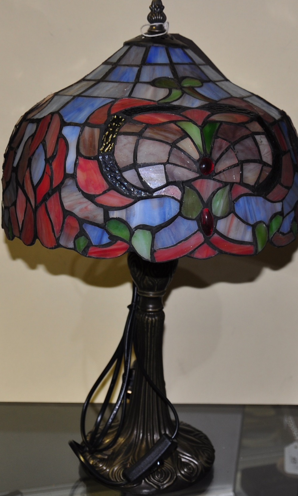 A Tiffany style coloured glass lamp,