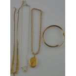 A collection of 9ct yellow gold jewellery comprising an oval portrait locket, a hollow bangle,