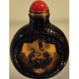 A Chinese Peking snuff bottle decorated with a tiger