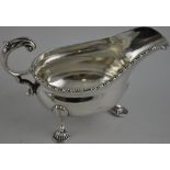 A large silver sauce boat on three cast shell feet,