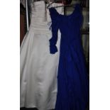 A strapless ivory wedding dress, together with a blue 1980's bridesmaid dress.
