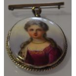A porcelain portrait brooch of an aristocratic lady in oval white metal frame