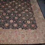 A Persian style black ground carpet, woven with flower heads, approximately 300 x 200 cm.