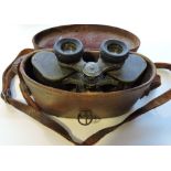 A pair of early 20th Century tan leather cased binoculars,