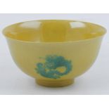 A Chinese yellow ground bowl, decorated in green with dragons, bears six character mark to base. D.