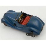 A Schuco  Examico 4001 clockwork toy car, with dark blue livery and red interior,