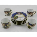 Four Nuritake cups and five saucers, decorated with river scenes on a blue and white ground.