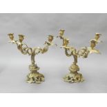 A pair of French ormolu four-branch candelabrum, in the Rococo taste, raised on 'c' scroll and