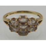 A 9 carat yellow gold and morganite cluster ring, set seven oval cut morganite.