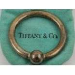Tiffany & Co., New York. A silver baby's rattle, stamped 925, in original gift pouch and box.