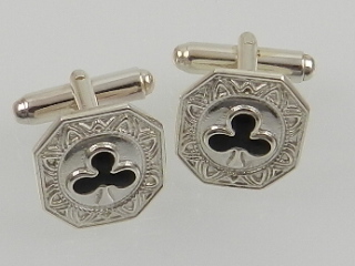 A pair of silver and enamel cuff links.