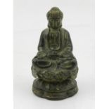 A bronze study of Buddha, seated on a lotus stand, bears Oriental characters to base. H.