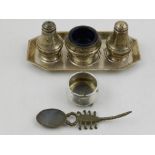 A silver cruet set, Birmingham, the three items on a rectangular tray with canted corners,