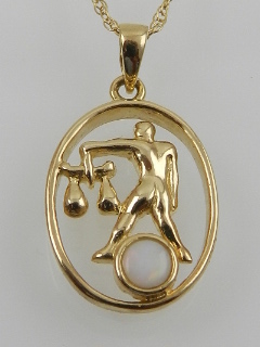 A 9 carat yellow gold and opal set pendant, suspended on a 9 carat yellow gold chain.