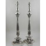 A pair of Empire style plated table lamps, fashioned as Corinthian columns, raised on triform bases.