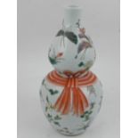A Chinese double gourd porcelain vase, decorated in the famille rose palette with butterflies