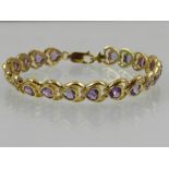 A silver gilt and amethyst set bracelet, in original box.