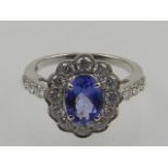 An 18 carat white gold, tanzanite, and diamond cluster ring, the diamonds of approx. 2.