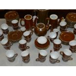 A large and comprehensive tea and coffee service, on a chocolate brown ground, by Pilivite of