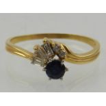 An 18 carat yellow gold, diamond, and sapphire cluster ring, set baguette and round cut diamonds,