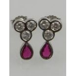 A pair of 18 carat white gold, diamond, and ruby earrings,