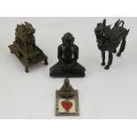 A carved soapstone Buddhist figure together with two other cast bronze pieces and a wist marker