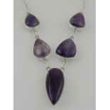A silver and amethyst five stone drop pendant necklace.