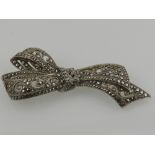 A silver and marcasite set bow-shaped brooch.