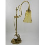 A brass standing table lamp, having glass shade. H.56cm