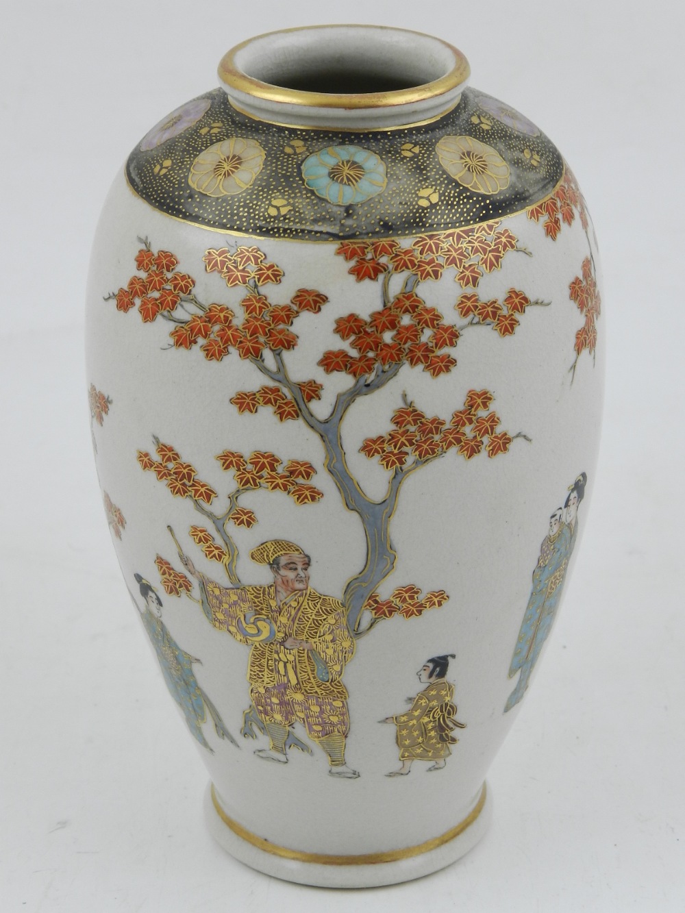 An early 20th century Japanese satsuma vase, decorated with figures below a tree, H. 16cm.