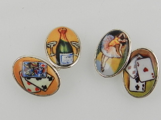 A pair of silver and enamel cuff links, of oval design,