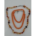 A carnelian necklace of uniform rounded beads,