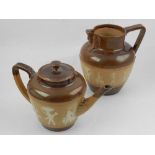 A Doulton Lambeth teapot and water jug, decorated with Egyptian figures,