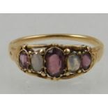 A yellow metal, amethyst and opal graduated five stone ring.