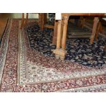 An red ground Tabriz carpet, having quatrefoil medallion to centre on a scrolling foliate ground,