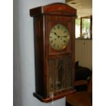 An early 20th century wall clock, the mahogany case with beaded moulding and glazed front,