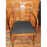 A 20th century mahogany open elbow armchair, having a black upholstered seat,