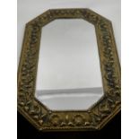 A wall mirror, the brass frame embossed with shells and scrolling foliage within a rope twist