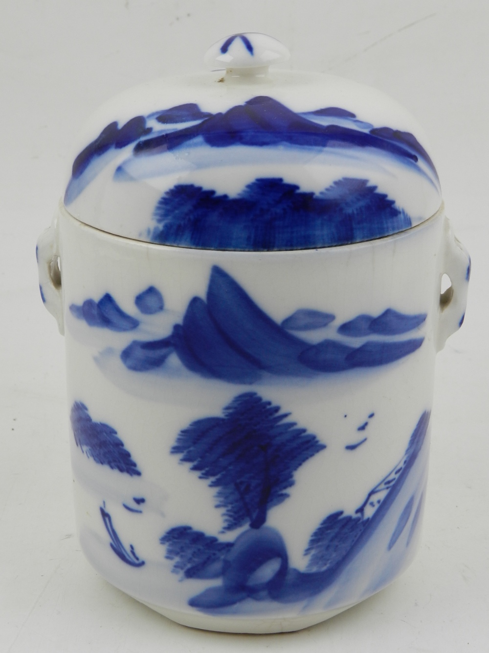 An 18/19th century blue and white Chinese twin handle cylindrical pot and cover,