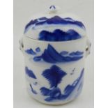 An 18/19th century blue and white Chinese twin handle cylindrical pot and cover,