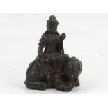 A South East Asian bronze of seated deity on elephant. H.