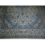 A Nain cream and blue ground Persian carpet, having a central medallion on floral ground, multi-