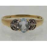A 9 carat yellow gold and aquamarine ring, set oval cut aquamarine in white metal reserves.