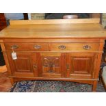 A 20th century oak buffet, having two drawers above three cupboard doors,
