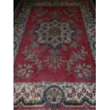 A red ground Tabriz carpet, having star shaped floral medallion to centre, multi-bordered and